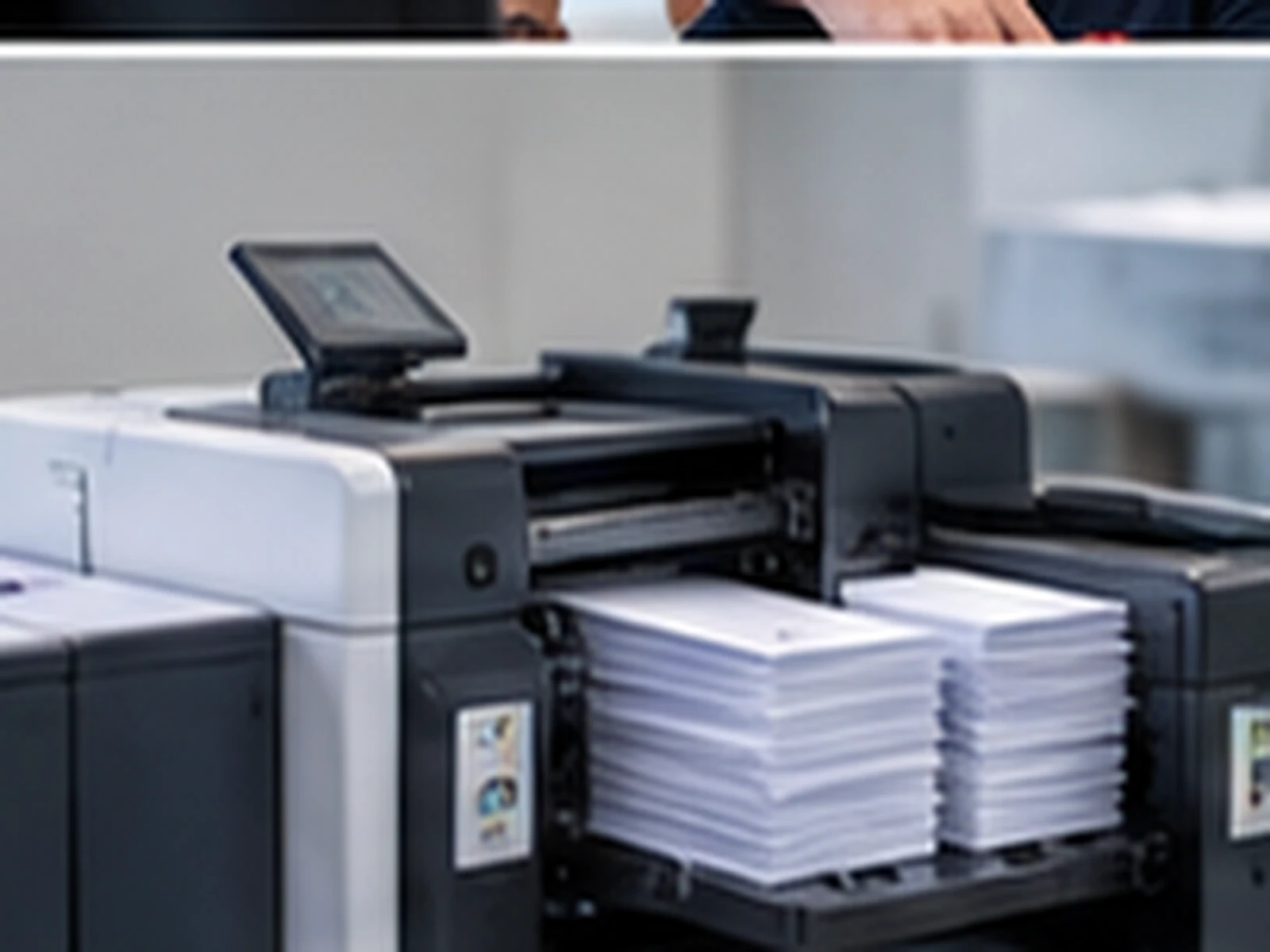 A folder inserter stacks finished, sealed envelopes.