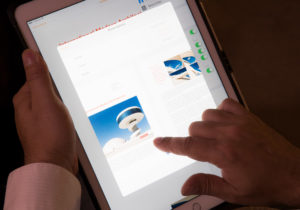 Hand scrolling image on iPad, closeup