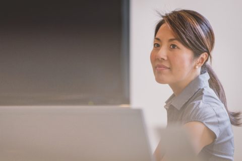 stock photo: woman looking up from desk