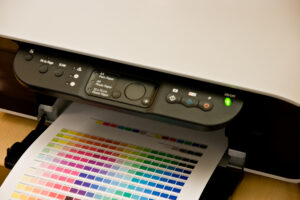 Closeup of out tray of a printer showing newly printed color swatch page
