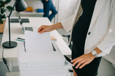 closeup of woman using office printer