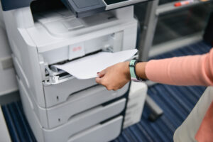 Woman using the printer to scan the document