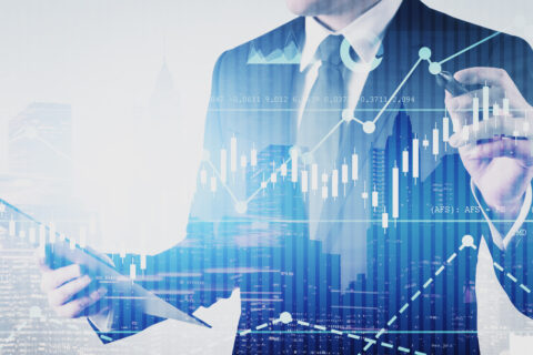 Young businessman with clipboard working with futuristic business interface with graphs. Concept of trading and hi tech. Toned image double exposure