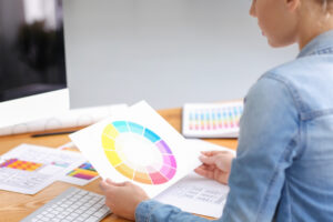 Young female designer working with color palette in office