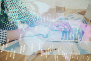 Multi exposure of stock market chart with man working on computer on background. Concept of financial analysis.
