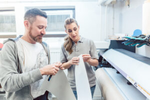 Man and woman discussing technical details of a large format print