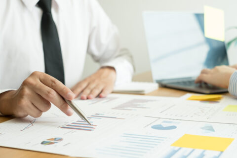 Two business leaders talk about charts, financial graphs showing results are analyzing and calculating planning strategies, business success building processes.