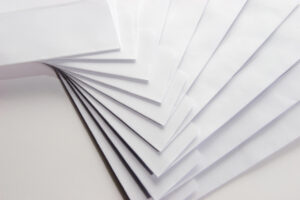 An assortment of white envelopes displayed in a stack