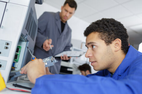 DEXpert technician repairing a printer at business place at work