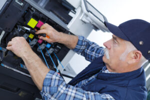 DEXpert technician opening photocopy machine in office
