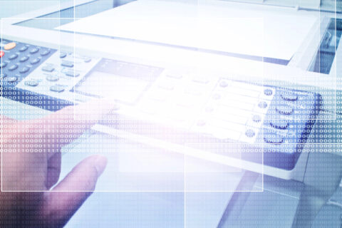 Abstract image of copier front panel with hand pressing a copier button