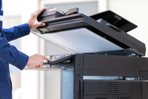 Businessman press button on panel of printer photocopier network , Working on photocopies in the office concept , printer is office worker tool equipment for scanning and copy paper.
