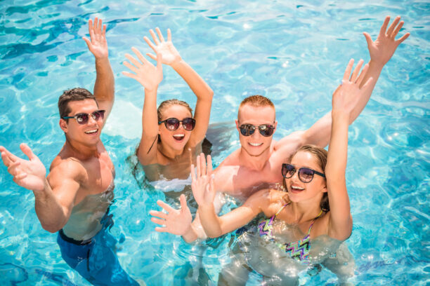 Beautiful,Young,People,Having,Fun,In,Swimming,Pool,,Smiling. Beautiful,Young,People,Having,Fun,In,Swimming,Pool,,Smiling.