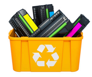 Used laser printer cartridges in recycling bin.