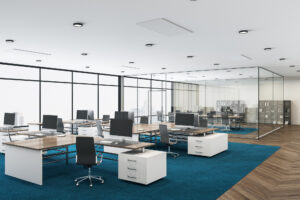 Luxury coworking office interior with computers on table and panoramic city view. Workplace and company concept.