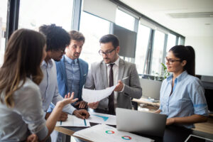 Group of workers gathered around a printout
