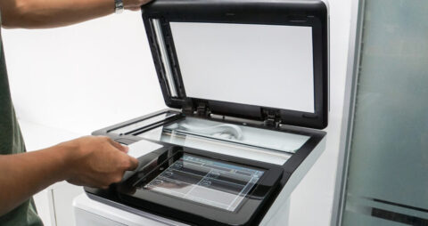 Office worker using security card to operate copier