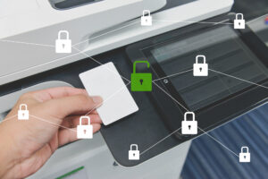 Closeup of worker using security card to unlock copier.