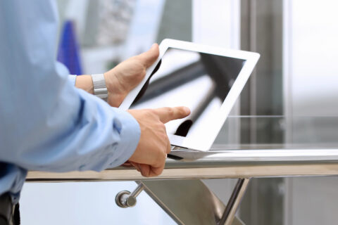 Businessman holding and using a digital tablet