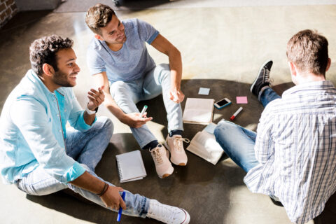 Group of young businessmen working on a project in a small business