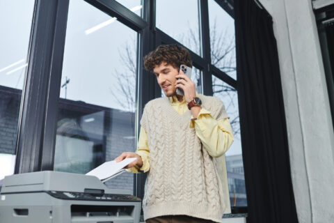 Young man using copier