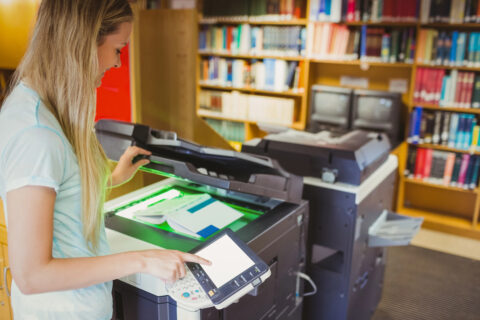 Woman in library making copies