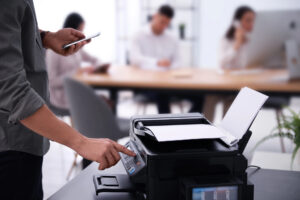 Closeup of office worker using a new copier