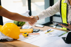 Handshake at construction office work table