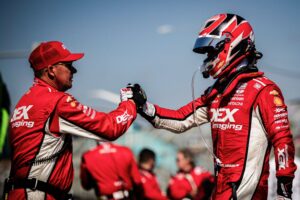 Team Penske driver Scott Mclaughlin accepts a handshake from his team captain