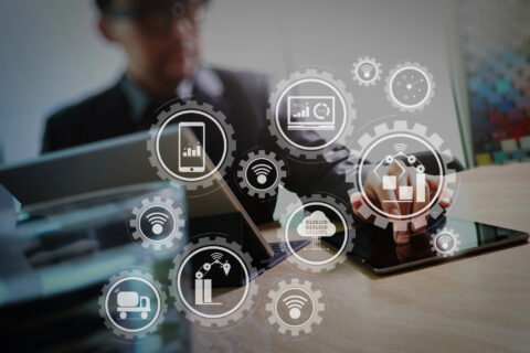 Smart factory and connected production robots exchanging data with internet of things (IoT) with cloud computing technology.Businessman hand touching digital tablet.