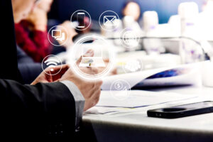 Businessman meeting in office with Tablet computers and smartphones: the interface of the future With online digital business hologram, business concept