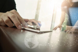 Two colleagues discussing data in office with new modern computer tablet