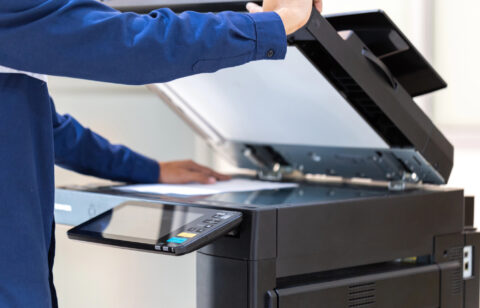 Businessman press button on panel of printer photocopier network , Working on photocopies in the office concept , printer is office worker tool equipment for scanning and copy paper. - stock image
