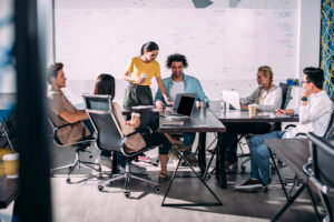 Conference room with group of workers collaborating around conference table