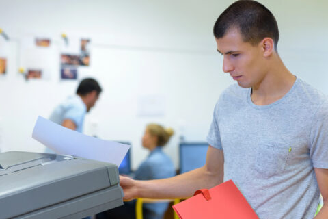 Man using copier in educational setting
