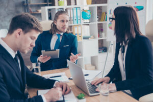 Three stylish trendy classic coworkers, wearing dark blue jacket