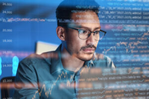 Laptop computer, code overlay and business man doing data analysis, coding technology and software overlay at night. Programmer or person focus on html script, programming statistics or cybersecurity research.