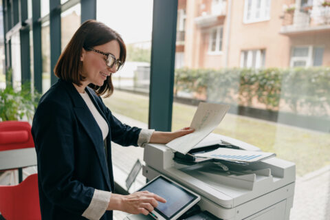 Businesswoman using copier in office