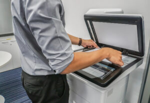 Close up businessman use printer to scan important and confidential documents in office