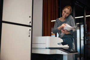 Busy worker on phone at office copier